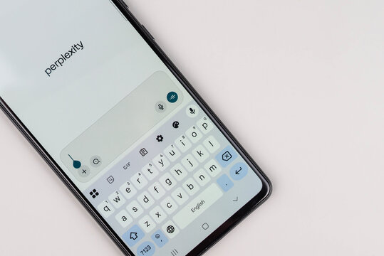 Rishon Lezion, Israel &ndash; 22.10.2025. Smartphone on desk displaying Perplexity app interface, symbolizing AI chat conversations, artificial intelligence, and modern technology.