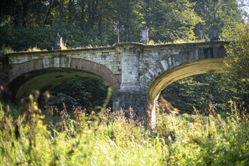An ancient bridge. A ruined bridge of the 18th century. Architecture of the past.