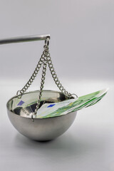 Money on balance scale symbolizing financial value.
