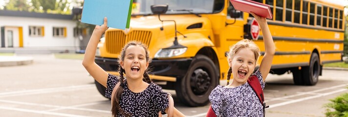 Little kids schoolchildren pupils students, the school bus. Welcome back to school. The new academic semester year start