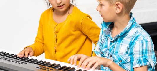 Brother And Sister Playing Piano