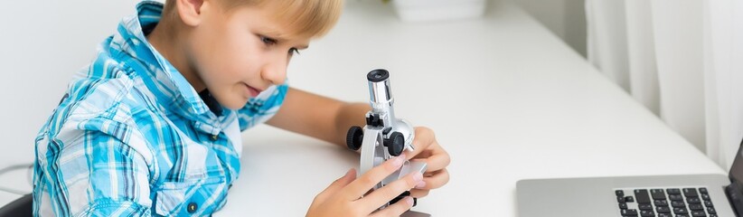 Using microscope. Children plays a scientists in lab by using equipment.