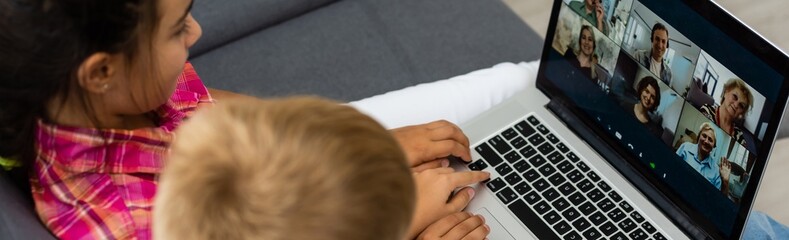  children sitting and using laptop