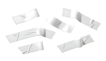 Collection of torn white adhesive tape pieces scattered on a transparent background.