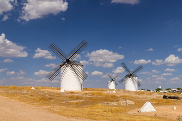 White windmills standing on arid landscape in Campo de Criptana