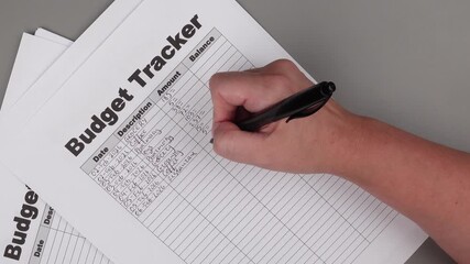 Open daily planner notebook on desk, with neatly handwritten organized Monthly Budget tracking table. With dates, categories and expenses. Personal finance management, spending and budgeting habits 