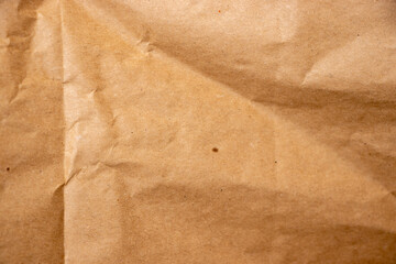 Close-up view of a crumpled brown paper background, showcasing its texture and tones, suitable for artistic or commercial use in packaging or crafts.