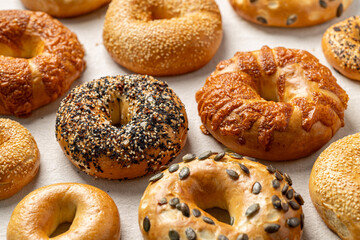 Assorted bagels on light fabric background
