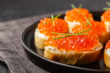 Fresh baguette canapes with red caviar and cream cheese