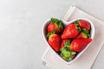 Fresh strawberries in heart bowl