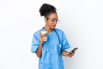 Young surgeon African American doctor woman isolated on white background holding coffee to take away and a mobile