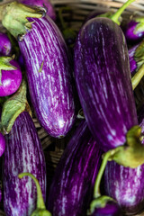 Background image of purple and white striped eggplant used for cooking.