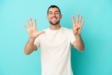 Young handsome caucasian man isolated on blue background counting nine with fingers