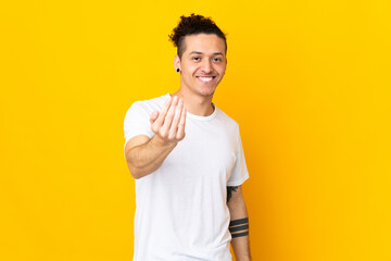 Caucasian man over isolated background inviting to come with hand. Happy that you came