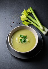 A comforting bowl of smooth, creamy celery soup, garnished with fresh herbs, offering a warm and nutritious meal option ,diet ,delicious ,fresh