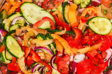 Vegetable salad in stainless steel bowl, top view close-up