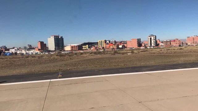 La Paz, Bolivia - June 02, 2025: Window view during long take-off run from runway 28 of El Alto International Airport SLLP. High altitude, slow climb.