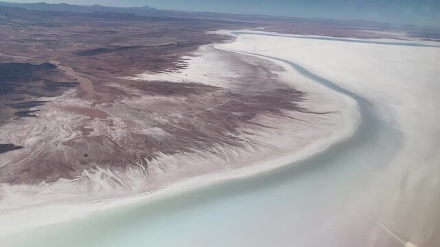View during approach to Joya Andina airport SLUY with outskirts of huge Salar de Uyuni and Andean highlands.
