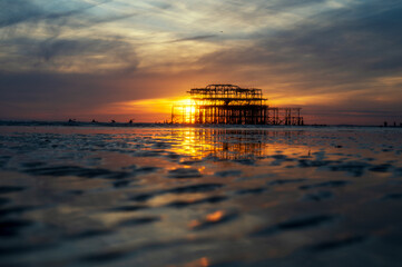 Sunset by the remains of Brighton's West Pier on a low tide