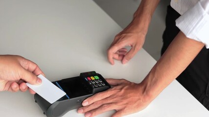 A customer making contactless payment by using credit card tapping near POS terminal. Modern technology concept. - Powered by Adobe