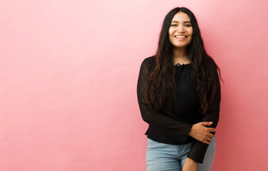 Portrait of hispanic woman smiling confidently in studio