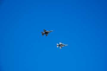 Two aircraft fighter jets against blue sky background. 8K resolution.