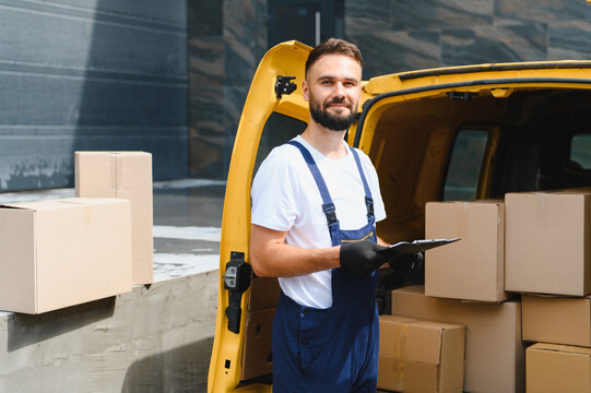 Deliveryman checking packages in a van with clipboard