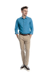 Happy casual man standing with hands in pockets