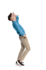 Side view of man shielding eyes and looking up