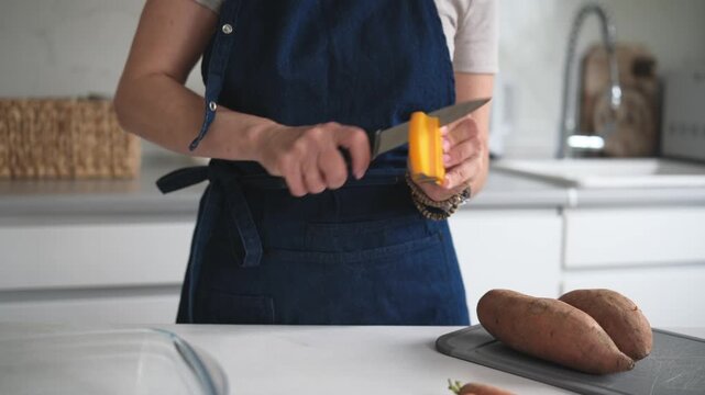 Woman Sharpening Knife In Close-Up View