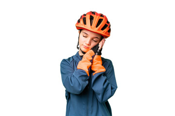Teenager cyclist girl over isolated chroma key background making sleep gesture in dorable expression