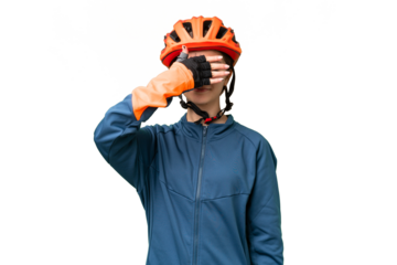 Teenager cyclist girl over isolated chroma key background covering eyes by hands. Do not want to see something