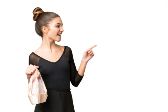 Teenager girl practicing ballet over isolated chroma key background pointing finger to the side and presenting a product