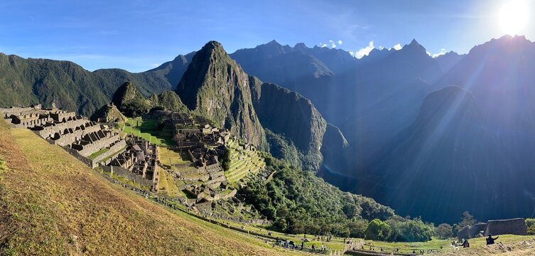 Aguas Calientes, Peru - May 27, 2025: Panoramic view of UNESCO World Heritage Site Machu Picchu with ancient houses, agricultural terraces, Huayna Picchu mountain and Urubamba Canyon.