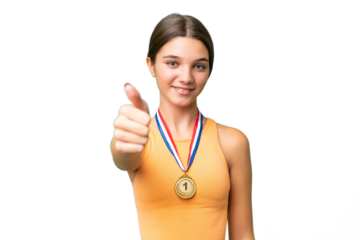 Teenager caucasian girl with medals over isolated background with thumbs up because something good has happened