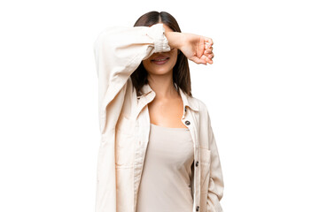 Young Russian woman over isolated chroma key background covering eyes by hands