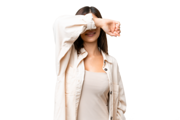 Young Russian woman over isolated chroma key background covering eyes by hands