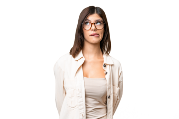 Young Russian woman over isolated chroma key background having doubts while looking up