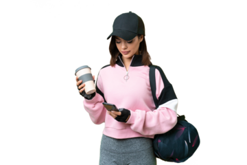 Young sport woman with sport bag over isolated chroma key background holding coffee to take away and a mobile
