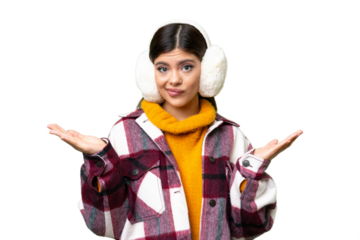 Young Russian woman wearing winter muffs over isolated chroma key background having doubts while raising hands