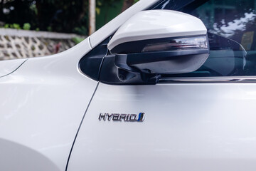 Hybrid emblem on the white car