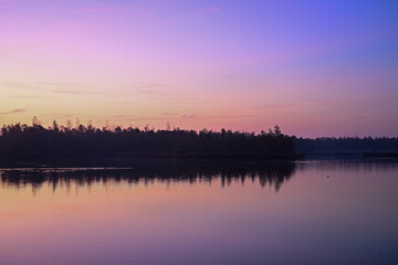 Fototapeta premium Vibrant Pre-Dawn Hues: Intense Pink and Purple Sky Reflected in Biesbosch Water
