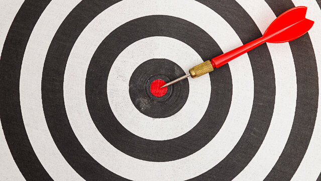Perfect Aim Dart Hitting the Bullseye, target accuracy concept, perfect accuracy.