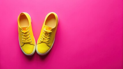 Fototapeta premium Bright Yellow Canvas Shoes on Vibrant Pink Background A Fashionable Footwear Image