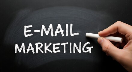 Email marketing text written on a blackboard with chalk by a hand