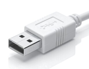 A close-up shot of a white USB connector angled to the left. It sits on a white background with a reflection