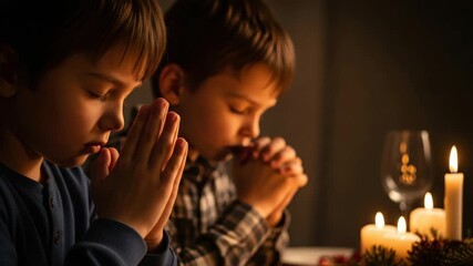 Two young boys praying together by candlelight. Children with closed eyes and clasped hands in a moment of faith and gratitude. Religious family tradition concept - Powered by Adobe