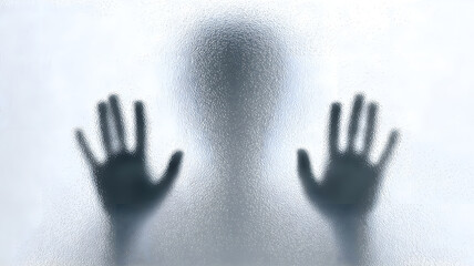 A dark silhouette of a person s head and hands pushing against a frosted glass surface conveying a mood of mystery isolation or a plea for help