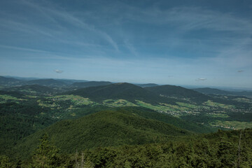View of the mountains covered with forests and the towns below them.

