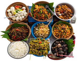 A vibrant assortment of traditional Asian dishes served in colorful bowls and plates on a dining table